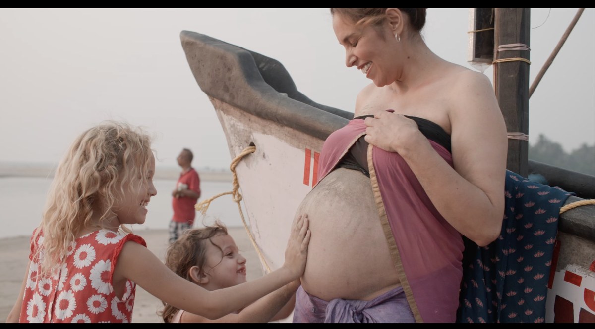 Salima, two weeks before giving birth, with her daughters on the beach in Goa, India
